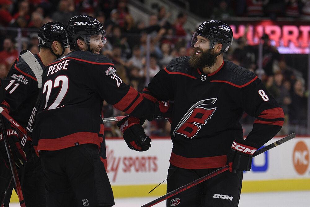 Defenseman Brett Pesce celebrates defenseman Brent Burns' goal in the game against the New York Islanders in PNC Arena on Friday, Oct. 28, 2022. Burns had six attempts blocked and one goal. The Hurricanes lost 6-2.