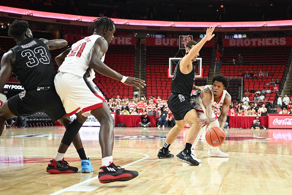 Freshman guard LJ Thomas passes the ball to junior forward Ebenezer Dowuona during the game against Florida International University on Tuesday, Nov. 15, 2022 in PNC Arena. NC State beat Florida International University 107-74.