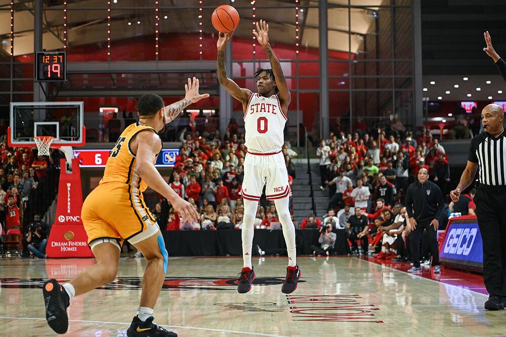 Sophomore guard Terquavion Smith shoots a 3-pointer during the annual Heritage Game against Coppin State in Reynolds Coliseum on Tuesday, Dec. 6, 2022. Smith led in scoring with 33 points and seven assists for the Wolfpack. NC State beat Coppin State 94-72.