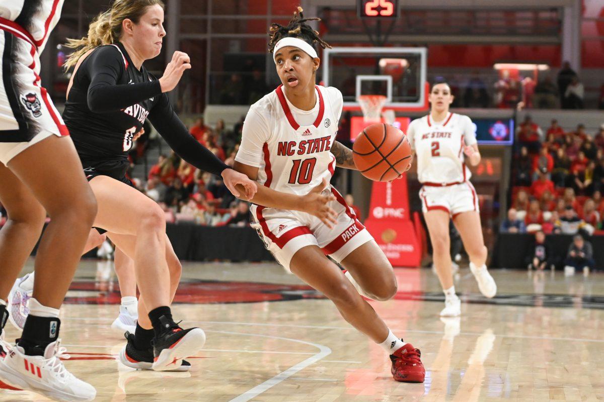 Sophomore guard Aziaha James dribbles the ball towards the basket during the game against the Davidson Wildcats in Reynolds Coliseum on Dec. 15, 2022. James scored 19 points throughout the game. NC State beat Davidson 81-47.