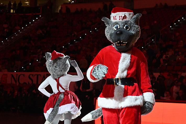 Mr. and Ms. Wuf cheer on the Wolfpack&#160;during the game against Louisville at PNC Arena on Thursday, Dec. 22, 2022. The Wolfpack beat the Cardinals 76-64.