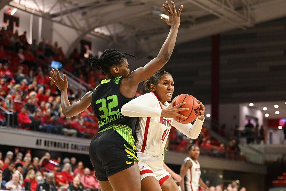 Senior center Camille Hobby drives the ball around an opponent during the game against USF in Reynolds Coliseum on Sunday, Dec. 11, 2022. Hobby scored 10 points and made seven rebounds for the Wolfpack. NC State beat USF 65-57.