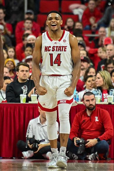 Senior guard Casey Morsell celebrates scoring during the game against Louisville at PNC Arena on Thursday, Dec. 22, 2022. Morsell made three field goals and three 3-pointers. The Wolfpack beat the Cardinals 76-64.