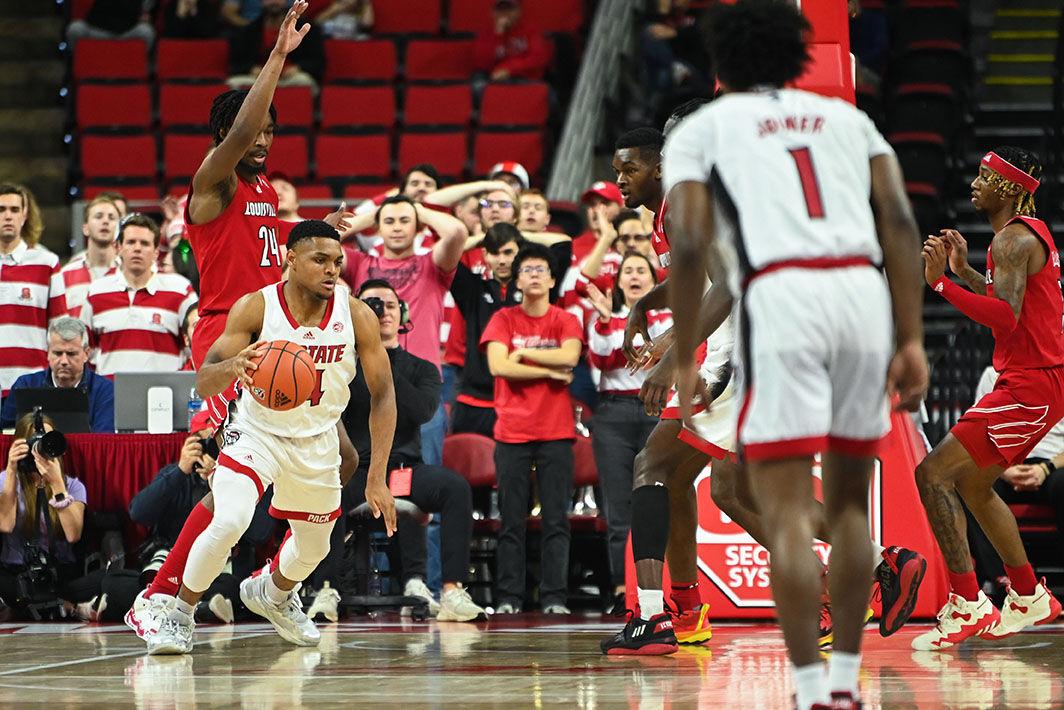 Senior guard Casey Morsell evades defenders during the game against Louisville at PNC Arena on Thursday, Dec. 22, 2022. Morsell made three field goals and three 3-pointers. The Wolfpack beat the Cardinals 76-64.