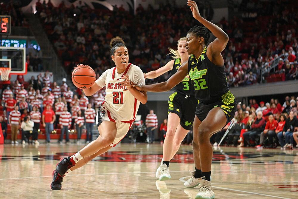 Junior guard Madison Hayes drives the ball to the basket during the game against USF in Reynolds Coliseum on Sunday, Dec. 11, 2022. Hayes made three assists, three steals and two rebounds. NC State beat USF 65-57.