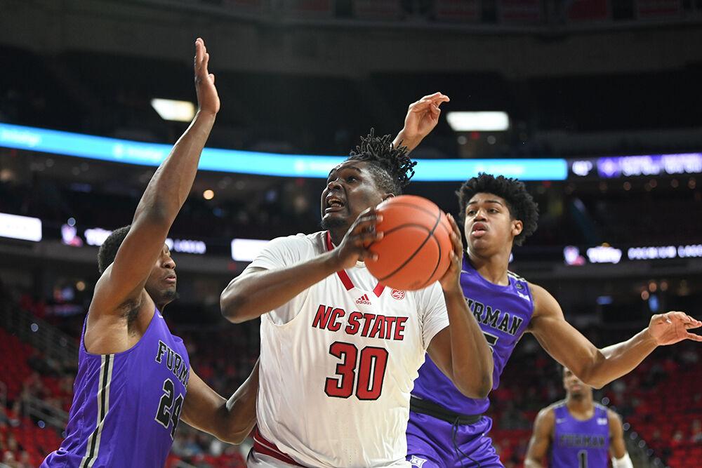 Graduate forward DJ Burns looks to shoot the ball over the block during the game against Furman in PNC Arena on Tuesday, Dec. 13, 2022. Burns scored seven points and made five rebounds for the Wolfpack. NC State beat Furman 92-73.