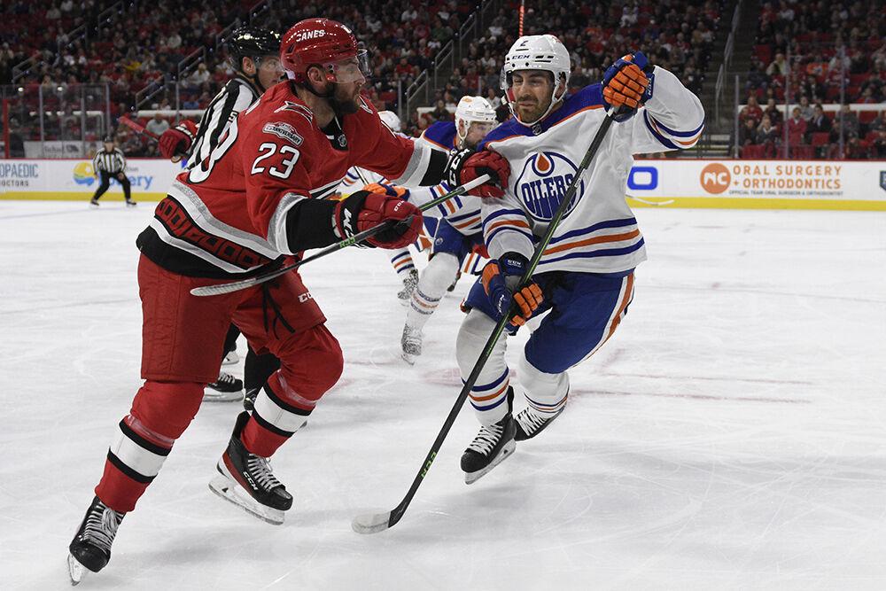 Carolina right wing Stefan Noesen fights an Oilers defender for position after a faceoff during the Hurricanes' home game against the Edmonton Oilers on Thursday, Nov. 10, 2022 in PNC Arena. The Canes beat the Oilers 7-2.