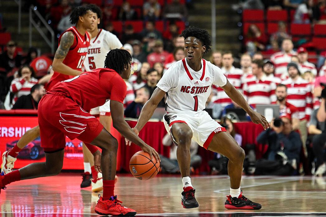 Freshman guard Casey Morsell evades defenders during the game against Louisville at PNC Arena on Thursday, Dec. 22, 2022. Morsell made three field goals and three 3-pointers. The Wolfpack beat the Cardinals 76-64.