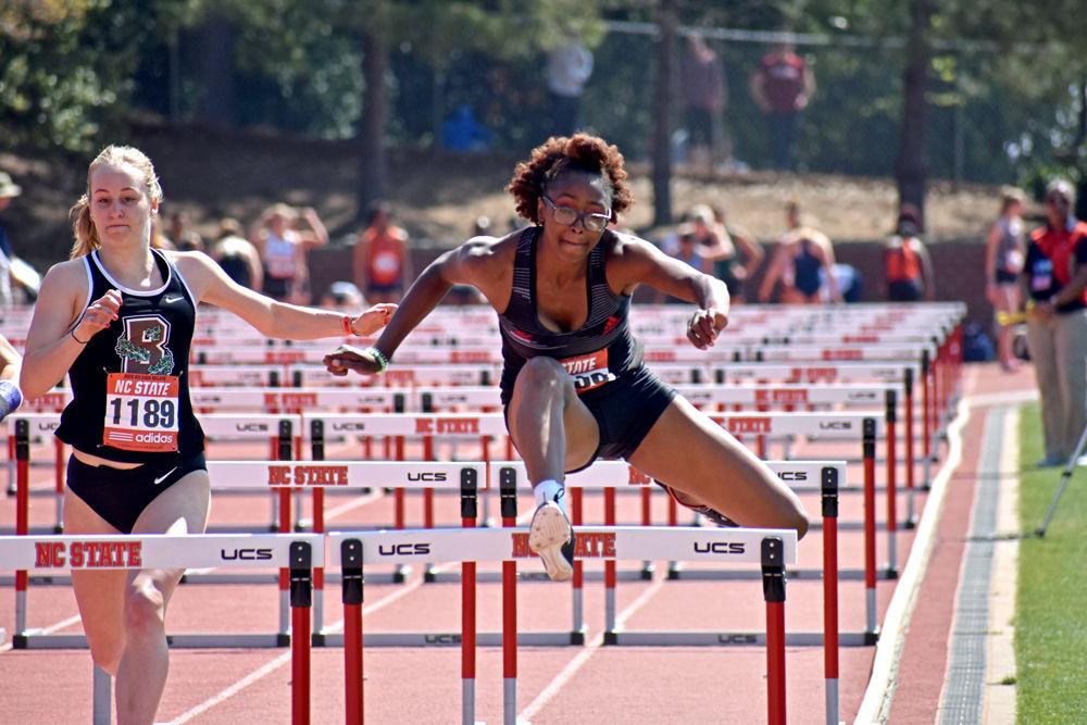 Freshman Timara Chapman leaps over the final hurdle as she finishes 17th overall in the women's 100m hurdles. Her time was 14.77 at the Raleigh Relays on Paul Derr Track on Friday, March 29, 2019.