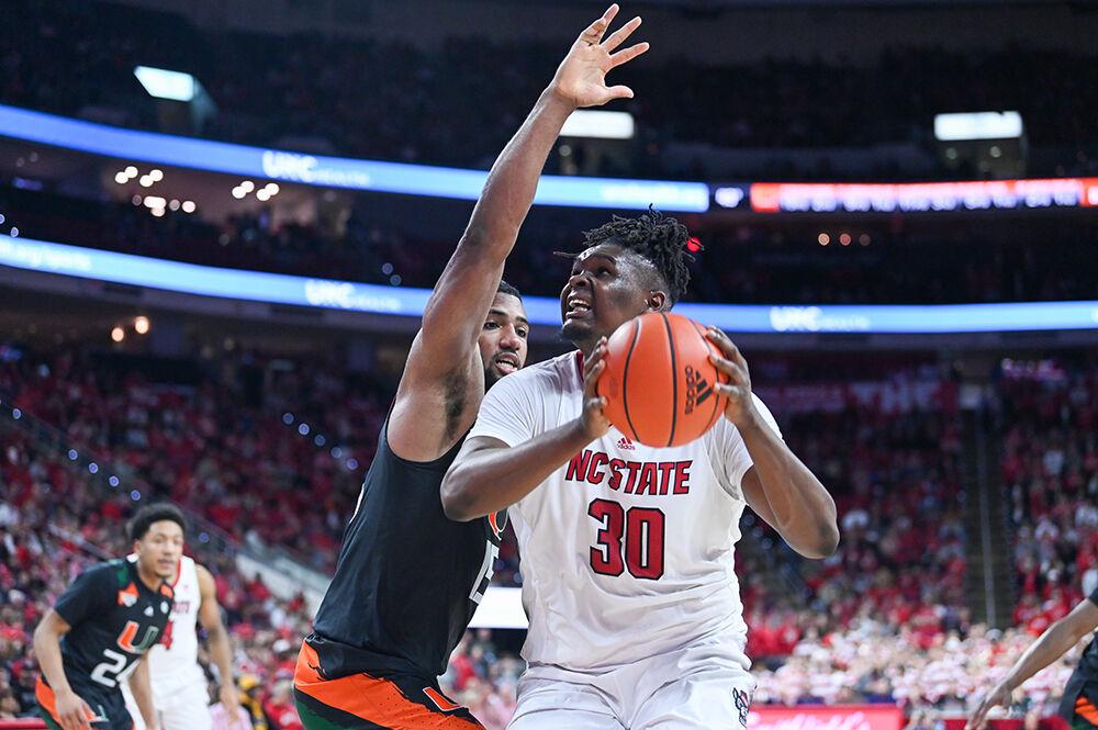 Graduate forward DJ Burns prepares the ball during the game against Miami in PNC Arena on Saturday, Jan. 14, 2023. Burns 13 points and nine rebounds. The Wolfpack won 83-81&#160;in overtime.