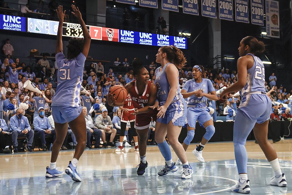 Junior guard Diamond Johnson holds off Tar Heel pressure during the Wolfpack's basketball game against the UNC-Chapel Hill Tar Heels in Carmichael Arena on Sunday, Jan. 15, 2023. The Wolfpack lost to the Tar Heels 56-47.