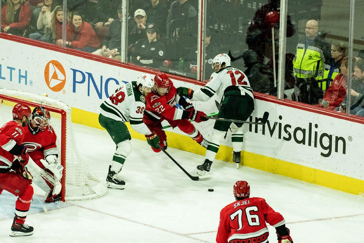 Defenseman Brett Pesce fights for control of puck during the game versus Minnesota in PNC Arena on Thursday, Jan. 19, 2023. Pesce made five shots on the opponent goal and blocked three attempts on his goal. The Hurricanes beat the Wild 5-2.