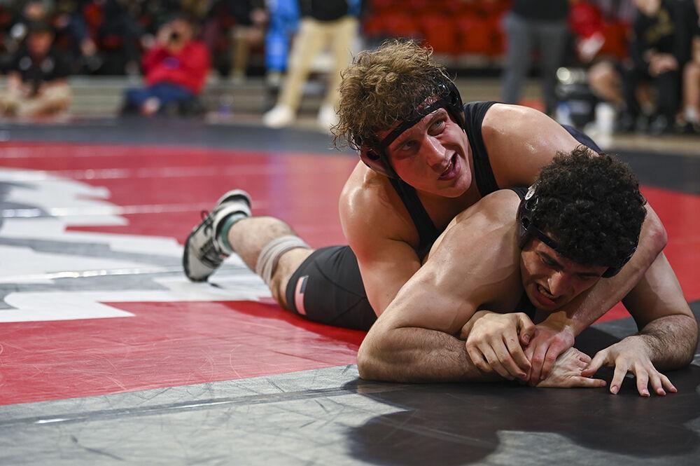 Redshirt junior Trent Hidlay keeps his opponent from escaping during the NC State duel against Army on Friday, Jan. 13, 2023 in Reynolds Coliseum. Hidlay won the 184 bout 13-5. NC State beat Army 30-6.