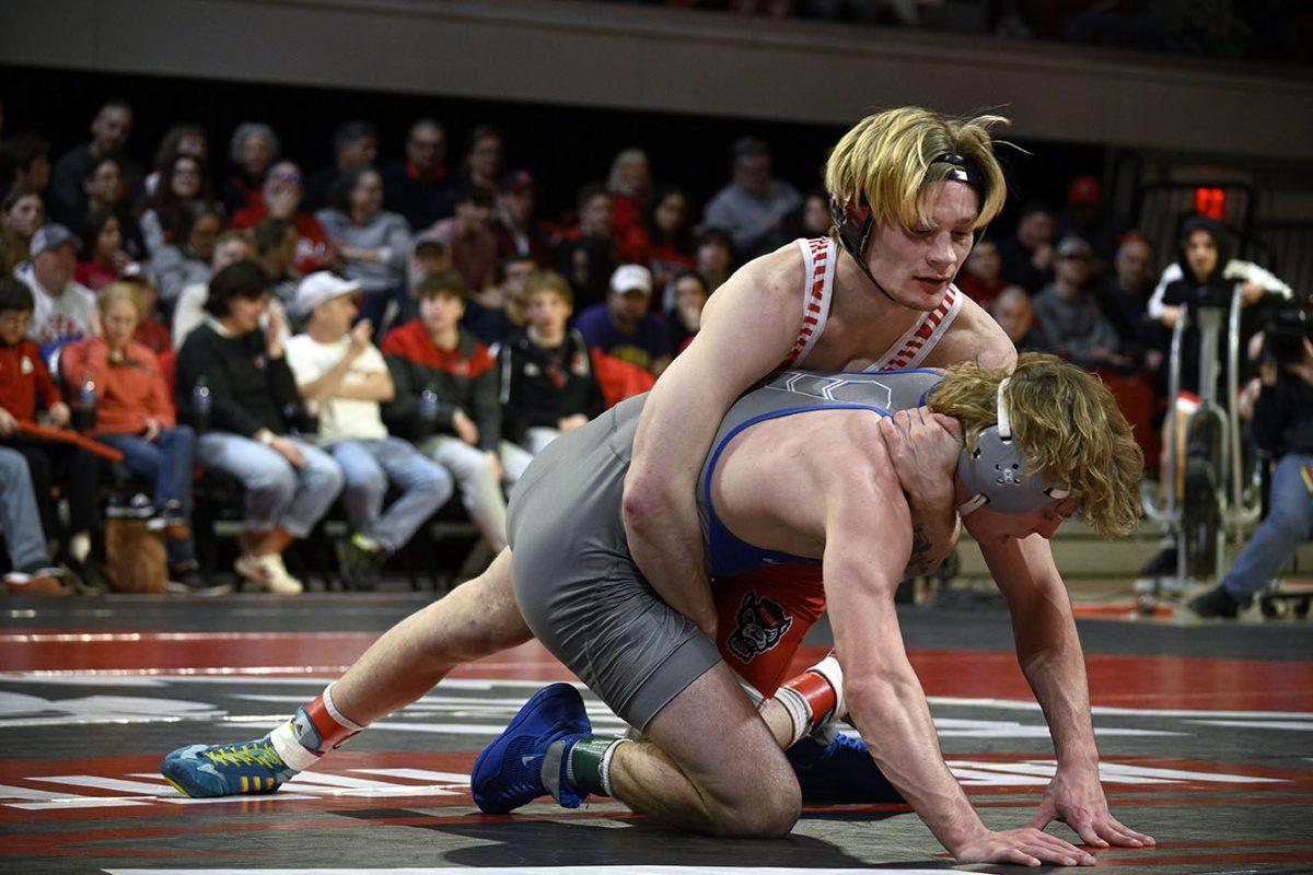Redshirt sophomore Kai Orine holds down his opponent during the NC State duel against Duke in Reynolds Coliseum on Friday, Jan. 27, 2023. Orine won his individual match 18-1. NC State beat Duke 43-6.