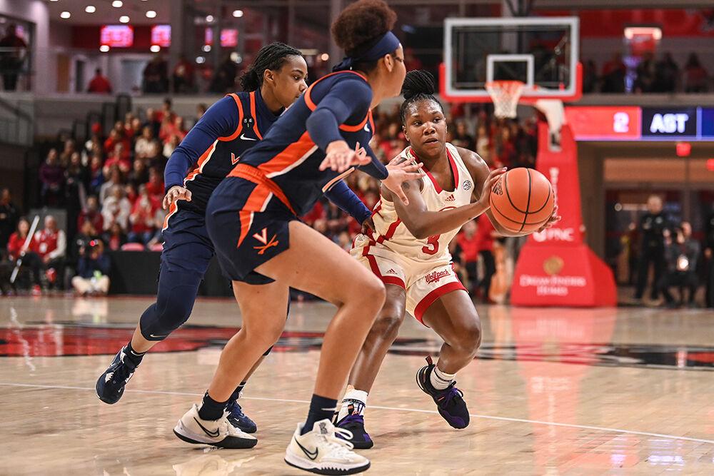 Junior guard Diamond Johnson passes the ball to a teammate during the game against Virginia in Reynolds Coliseum on Sunday, Jan. 8, 2023. Johnson scored 10 points and made four rebounds for the Wolfpack. NC State beat Virginia 87-62.