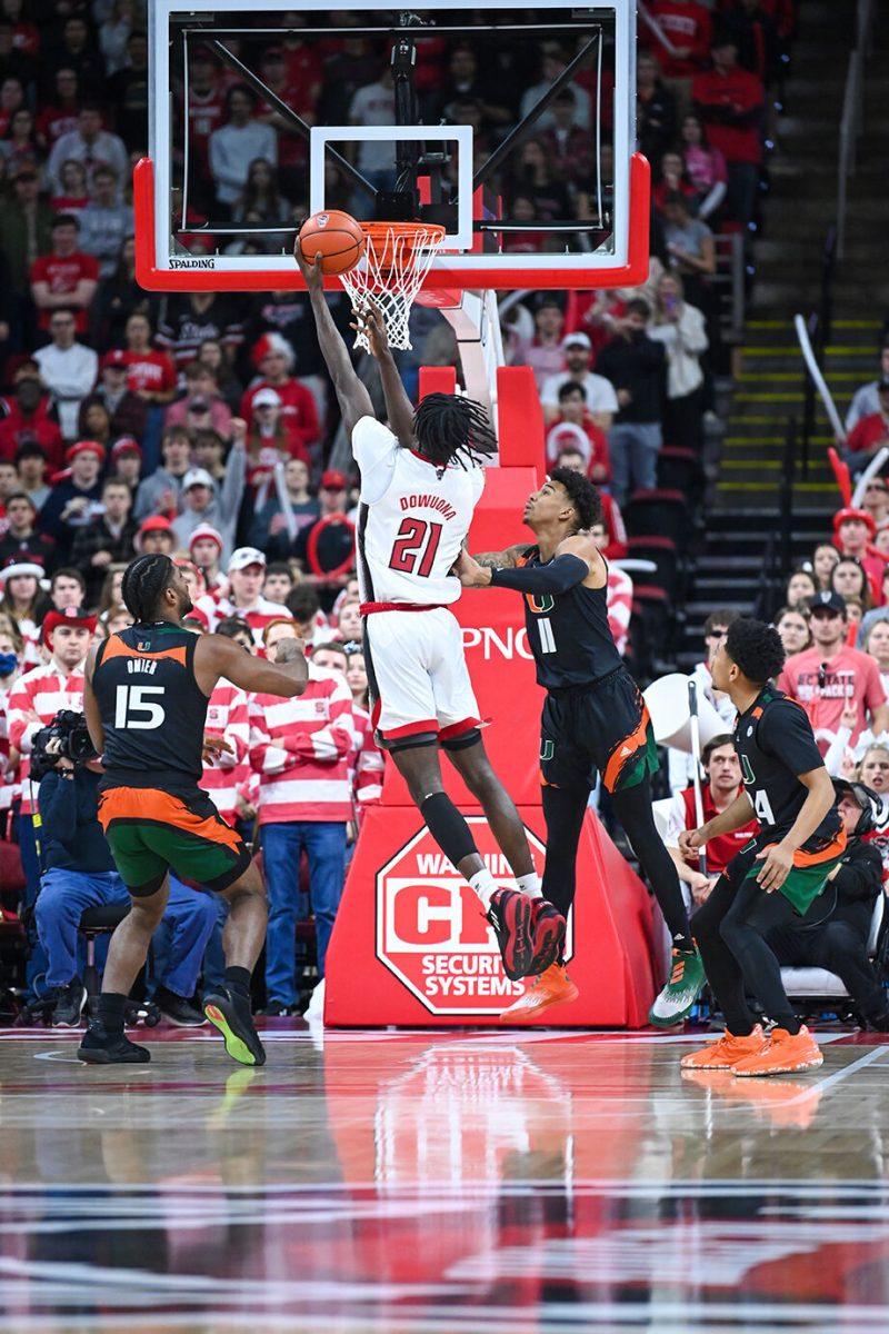 Junior forward Ebenezer Dowuona shoots the ball during the game against Miami in PNC Arena on Saturday, Jan. 14, 2023. Dowuona had two points and one rebound for NC State. The Wolfpack won 83-81&#160;in overtime.