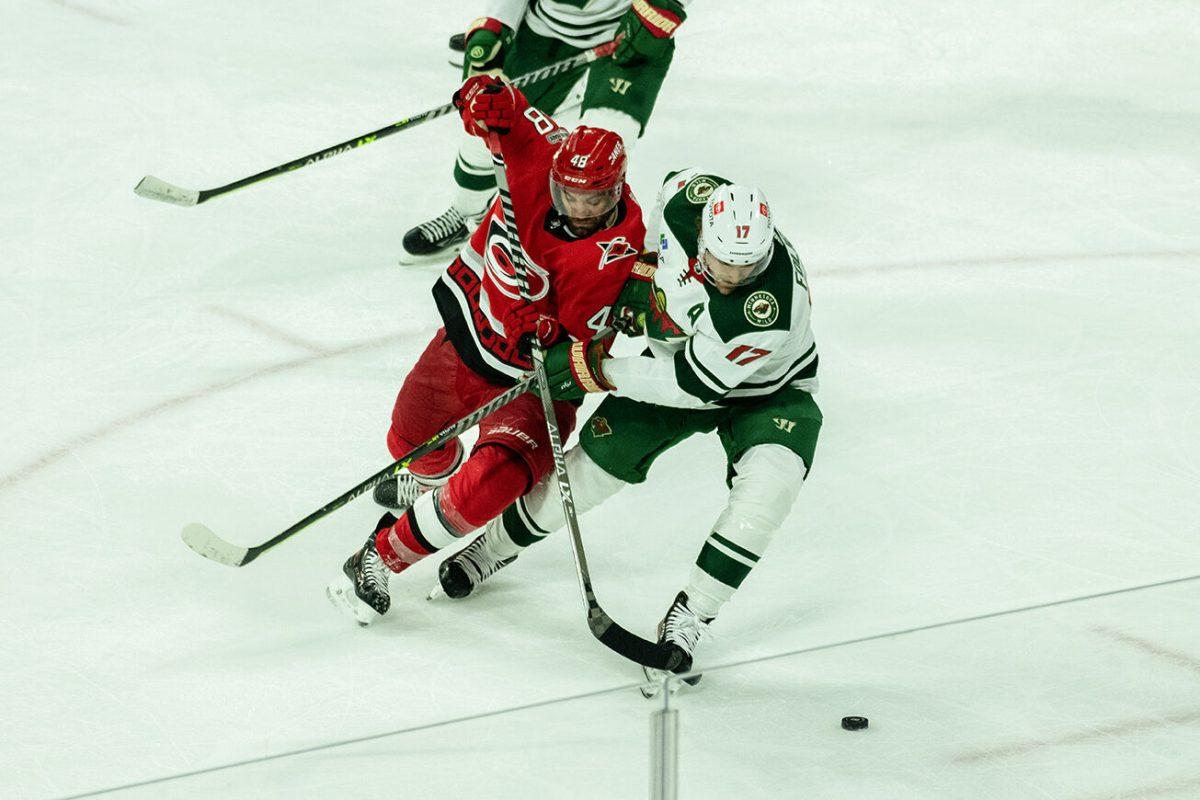 Left-Winger Jordan Martinook fights for control of puck during the game versus Minnesota in PNC Arena on Thursday, Jan. 19, 2023. Martinook made one shot on the goal. The Hurricanes beat the Wild 5-2.