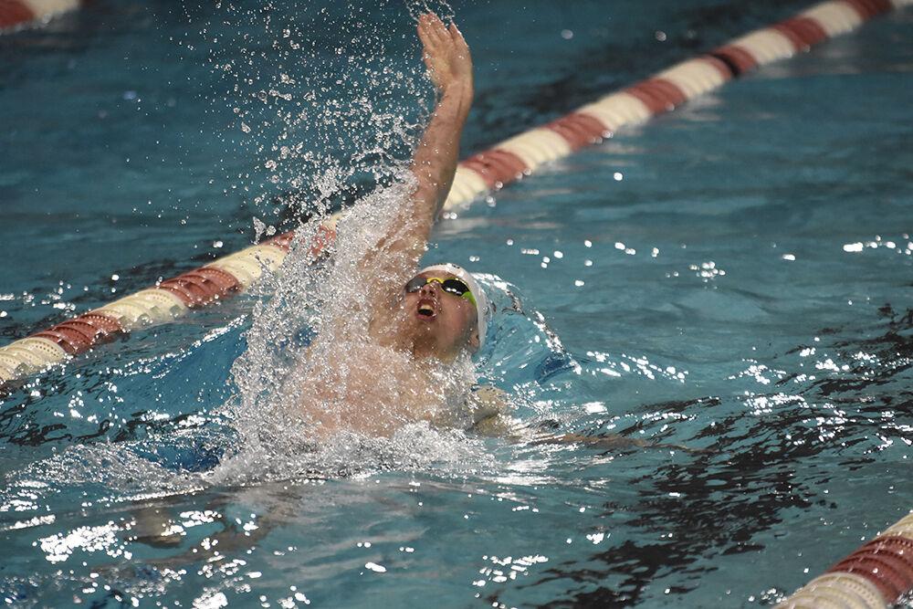 Senior Zachary Cram reaches his arm behind him in the men's 200-yard backstroke during the NC State Wolfpack's swimming and diving meet against the UNC-Wilmington Seahawks at the Willis R. Casey Aquatic Center on Friday, Jan. 27, 2023. Cram placed first in the heat with a 1:44.54. The Wolfpack men beat the Seahawks 160-126.