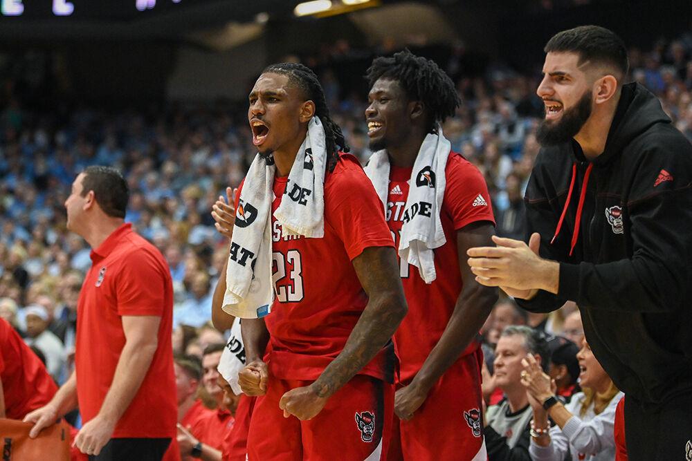 Redshirt junior forward Greg Gantt, junior forward Ebenezer Dowuona and graduate forward Dusan Mahorcic cheer on their teammates during the game against UNC-Chapel Hill in the Dean E. Smith Center on Saturday, Jan. 21, 2023. The Wolfpack lost to the Tar Heels 80-69.