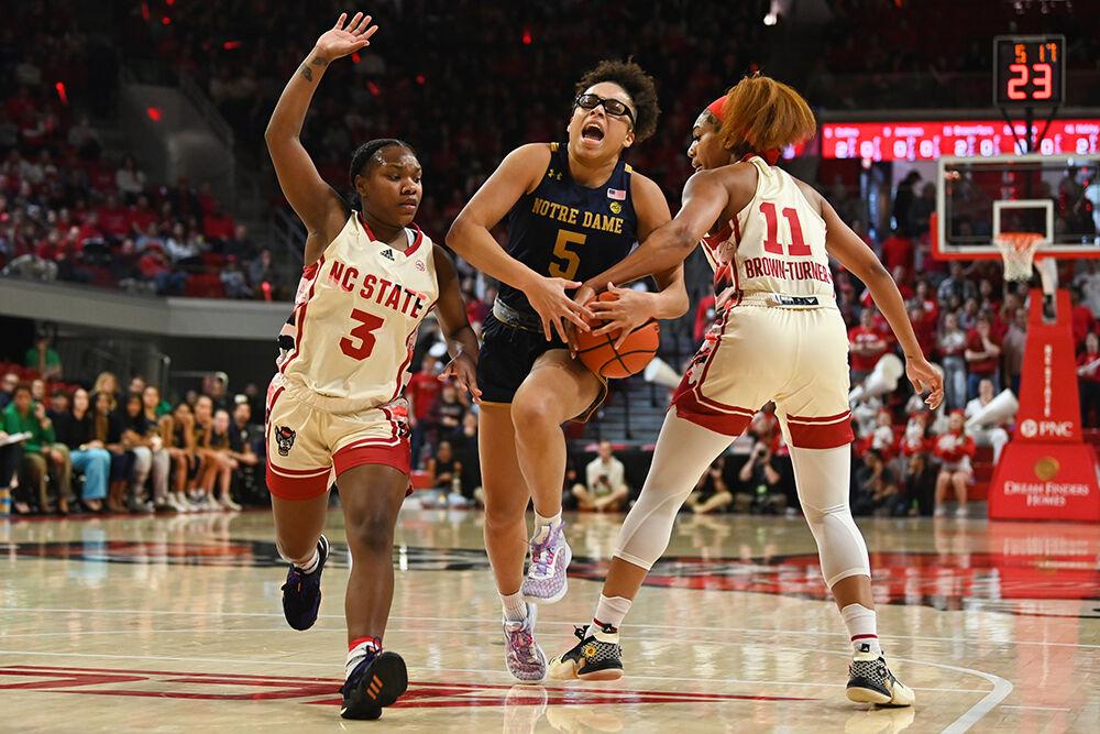 Junior guard Diamond Johnson and senior wing Jakia Brown-Turner defends Notre Dame opponent inside Reynolds Coliseum on Sunday, Jan. 29, 2023. The Wolfpack won 69-65.
