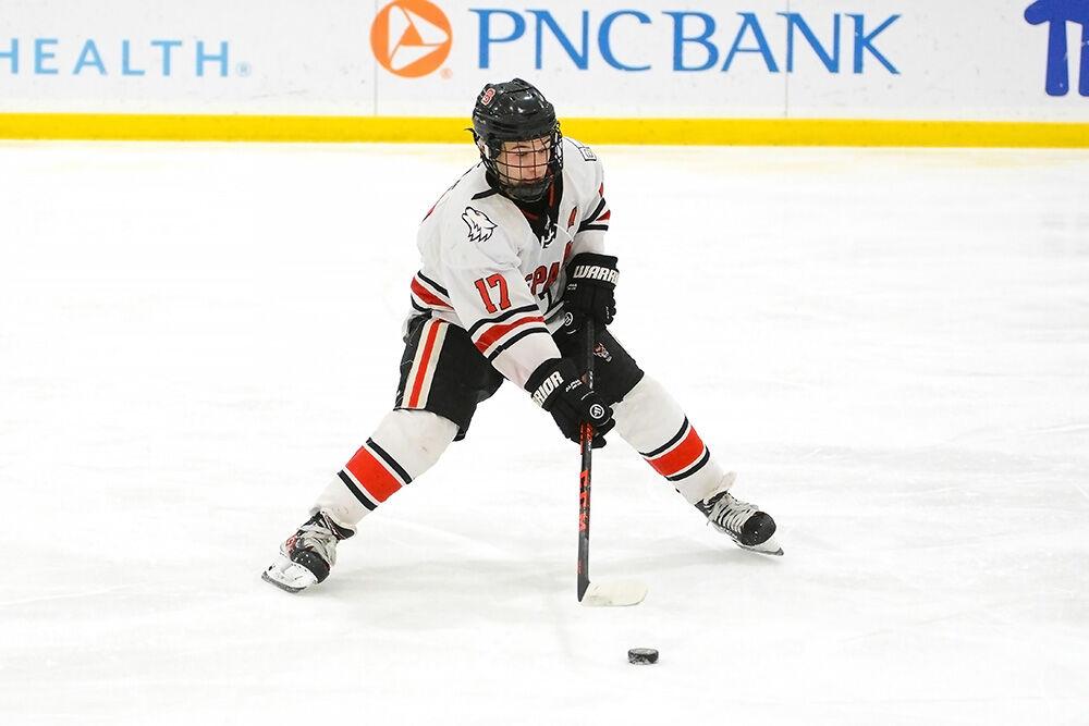 Senior forward Garrett Auriene passes the puck in the game versus University of Delaware at Wake Competition Center on Saturday, Jan. 14, 2023. The Icepack won with a 3-2 lead over the Blue Hens.