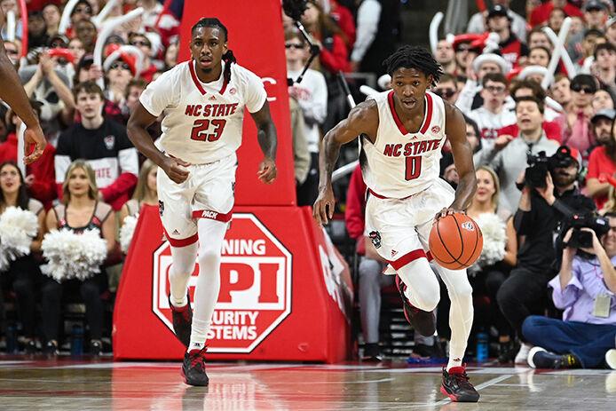 Redshirt junior forward Gregg Gantt (left) and sophomore guard Terquavion Smith (right) run across the court after gaining possession of the ball during the game against Miami in PNC Arena on Saturday, Jan. 14, 2023. The Wolfpack beat the Hurricanes 83-81&#160;in overtime.