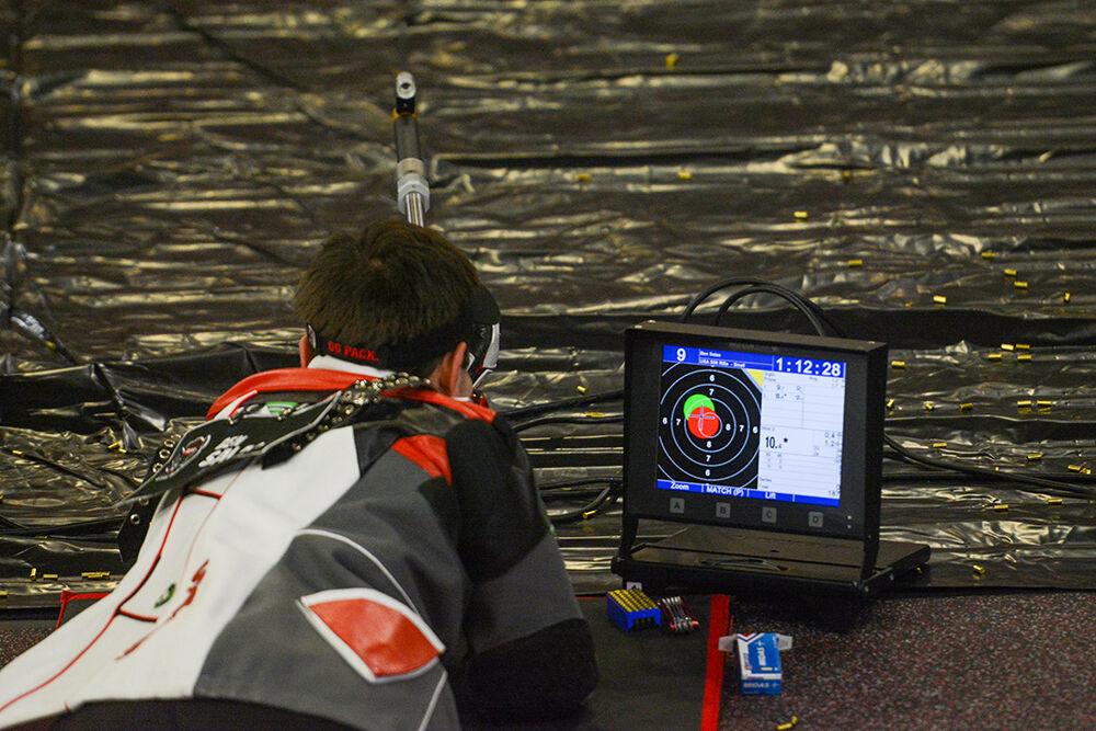 Sophomore Ben Salas aims at a target at the NC State versus West Virginia rifle match at Reynolds Coliseum on Sunday, Oct. 17, 2021. NC State lost&#160;4730-4652 against West Virginia.