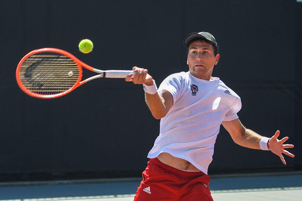 Sophomore Luca Staeheli makes a forehand swing during his singles match against UNC-Chapel Hill player Mac Kiger on Sunday, April 17, 2022 at the J.W. Isenhour Tennis Center. In spite of a mid-match injury, Staeheli won his singles match 2-1. NC State lost the overall match 4-3.