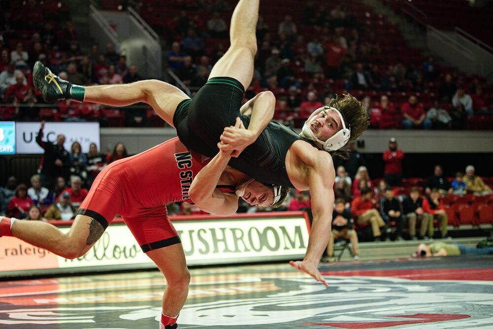 Redshirt Junior Alex Faison slams opponent during the meet versus Binghampton at Reynolds Coliseum on Friday Jan. 6, 2023. Faison beat his opponent 7-3. NC State beat Binghampton 36-3.