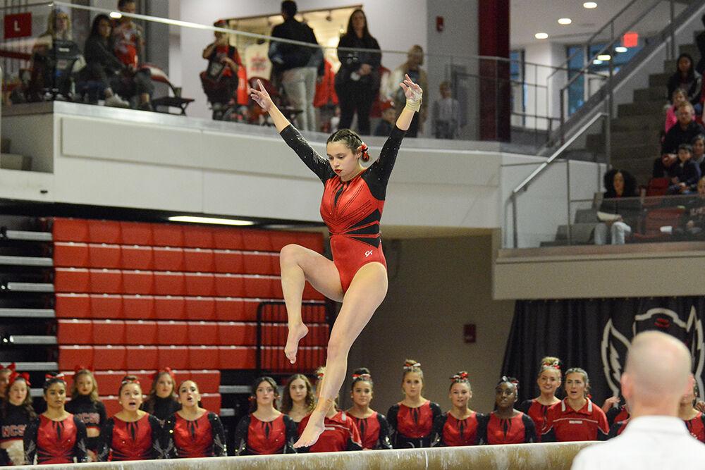 Senior gymnast Chloe Negrete performs on the beam during the meet against Pitt and George Washington University at Reynolds Coliseum on Saturday, Jan. 21, 2023. Negrete scored 9.900 on the beam and finished first in three different events. NC State beat Pitt and George Washington with an overall score of 196.650.