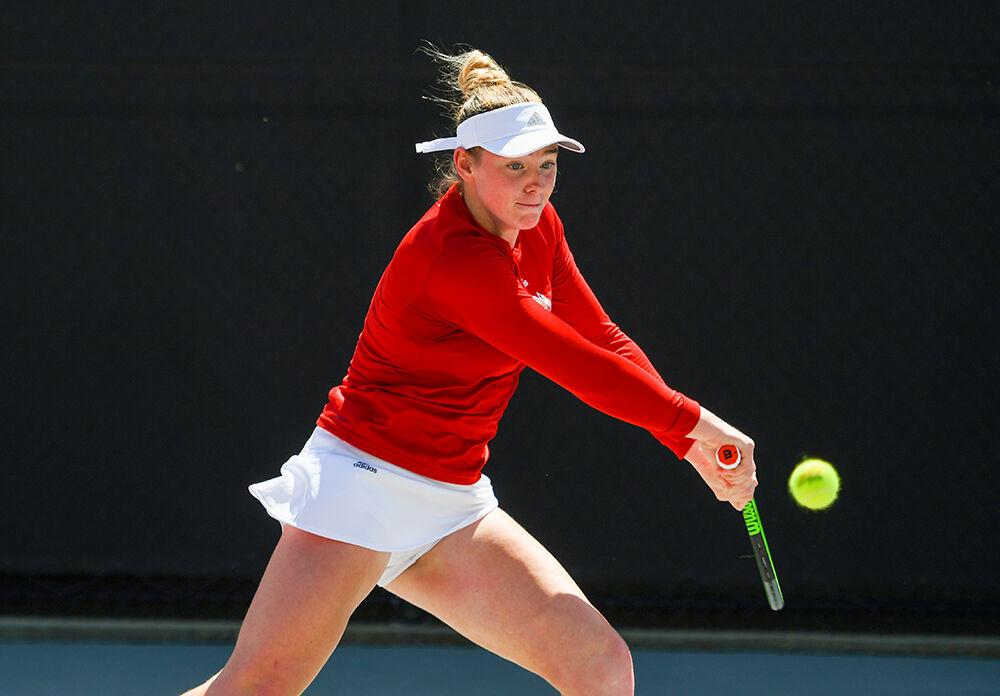 Sophomore Amelia Rajecki focuses on the ball and prepares to swing in her doubles match against Louisville on Friday, April 15, 2022 at the J.W. Isenhour Tennis Center. Rajecki and sophomore Abigail Rencheli's doubles match went unfinished, with NC State leading 5-1. The Wolfpack won the overall match 7-0.
