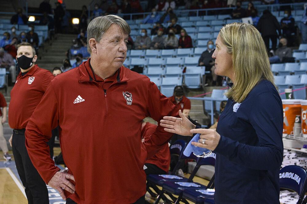 UNC's women's basketball coach, Courtney Banghart, talks to NC State's coach, Wes Moore, before the game in UNC's Carmichael Arena on Sunday, Jan. 30, 2022. NC State beat UNC 66-58.