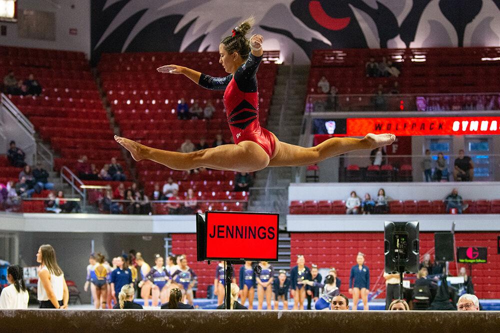 Senior Macy Jennings leaps on the balance beam during the gymnastics meet against Pitt and George Washington at Reynolds Coliseum on Saturday, Jan. 21, 2023. NC State beat Pitt and George Washington with an overall score of 196.650.