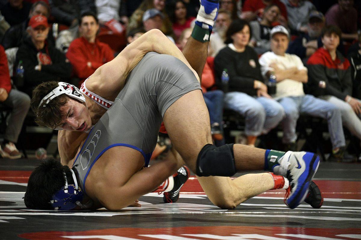 Redshirt freshman Luke Ahrberg pushes down his opponent during the NC State duel against Duke in Reynolds Coliseum on Friday, Jan. 27, 2023. Ahrberg won his match 7-2. NC State beat Duke 46-3.