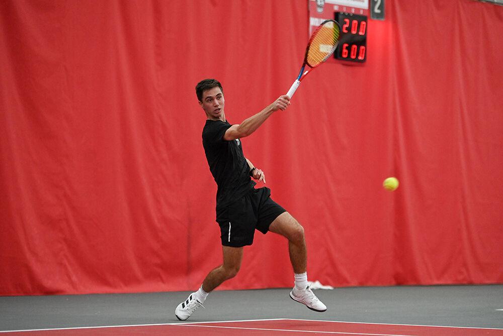 Redshirt sophomore Braden Shick returns the ball to his opponent during his singles match against Harvard player Daniel Milavsky at J.W. Isenhour Tennis Center on Friday, Jan. 20, 2023. Shick won the singles match 2-0. NC State lost 4-3 to Harvard.