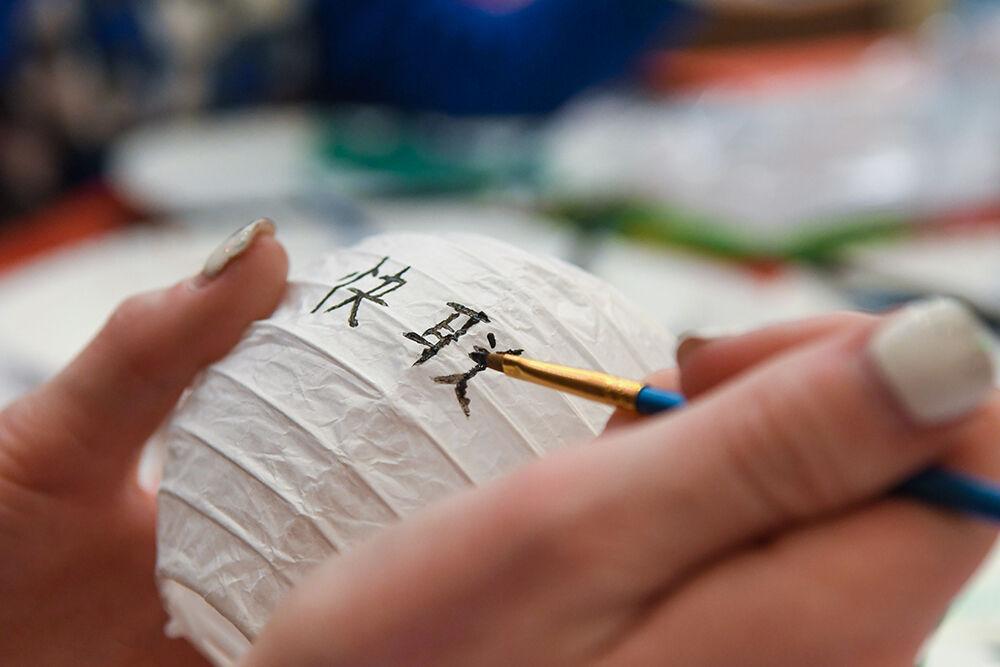 A student paints a Chinese lantern at the Lunar New Year Celebration on Tuesday, Feb. 1, 2022 in Talley Student Union. The celebration was for the start of the Year of the Tiger and had activities like painting, origami, music, food and games.