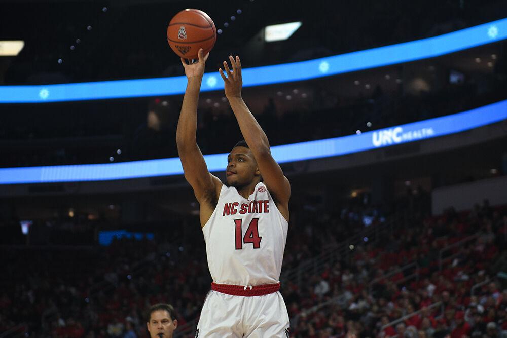 Senior guard Casey Morsell shoots a three during the Wolfpack's game against the Notre Dame Fighting Irish at PNC Arena on Tuesday, Jan. 24, 2022. Morsell shot for 11 points as the Wolfpack beat the Fighting Irish 85-82.