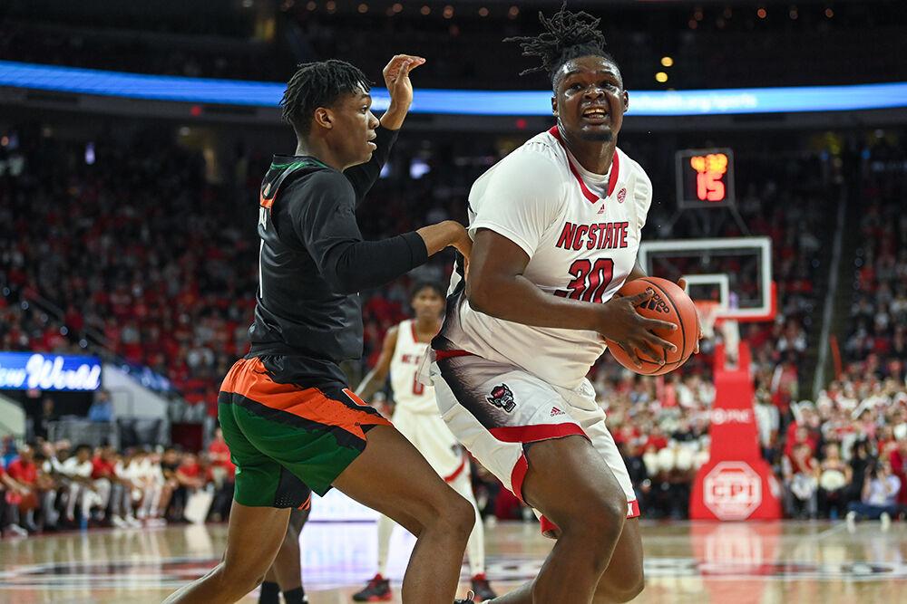 Graduate forward DJ Burns Jr. drives to the basket during the game against Miami in PNC Arena on Saturday, Jan. 14, 2023. Burns Jr. had nine rebounds and seven assists. The Wolfpack beat the Hurricanes 83-81&#160;in overtime.