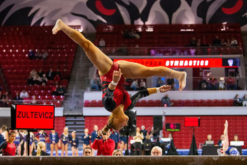 Junior Krista Zultevicz flips on the balance beam during the gymnastics meet against Pitt and George Washington at Reynolds Coliseum on Saturday, Jan. 21, 2023. NC State beat Pitt and George Washington with an overall score of 196.650.