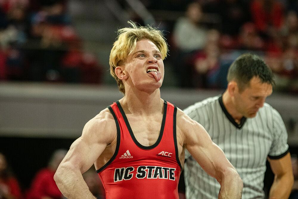 Redshirt sophomore Kai Orine flexes after beating his opponent during the duel against Binghampton at Reynolds Coliseum on Friday Jan. 6, 2023. Orine defeated his opponent 8-2. NC State beat Binghampton 36-3.