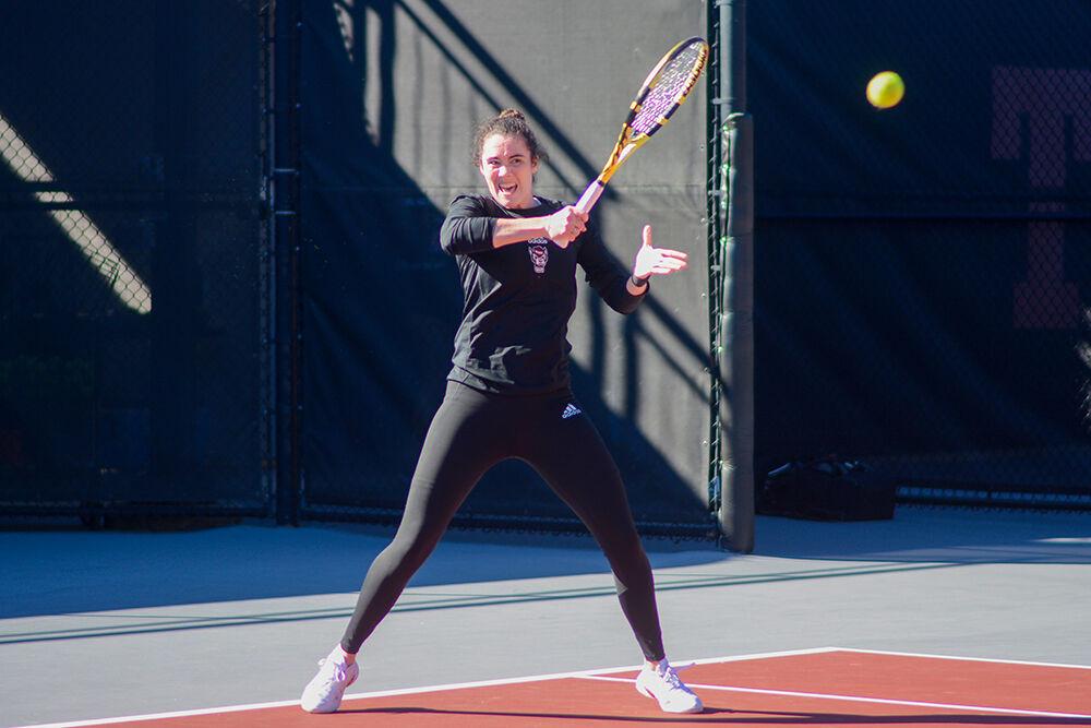 Fifth-year Nell Miller forehands the ball during the match against Illinois at the Dail Outdoor Tennis Stadium on Saturday, Jan. 28, 2023. Miller won her doubles match. The Wolfpack won the overall match 4-0.