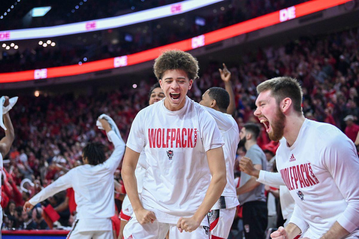 Freshman guard Jordan Snell (left) and Sophomore guard Alex Nunnally (right) errupt after winning the game against Miami in PNC Arena on Saturday, Jan. 14, 2023. The Wolfpack won 83-81&#160;in overtime.