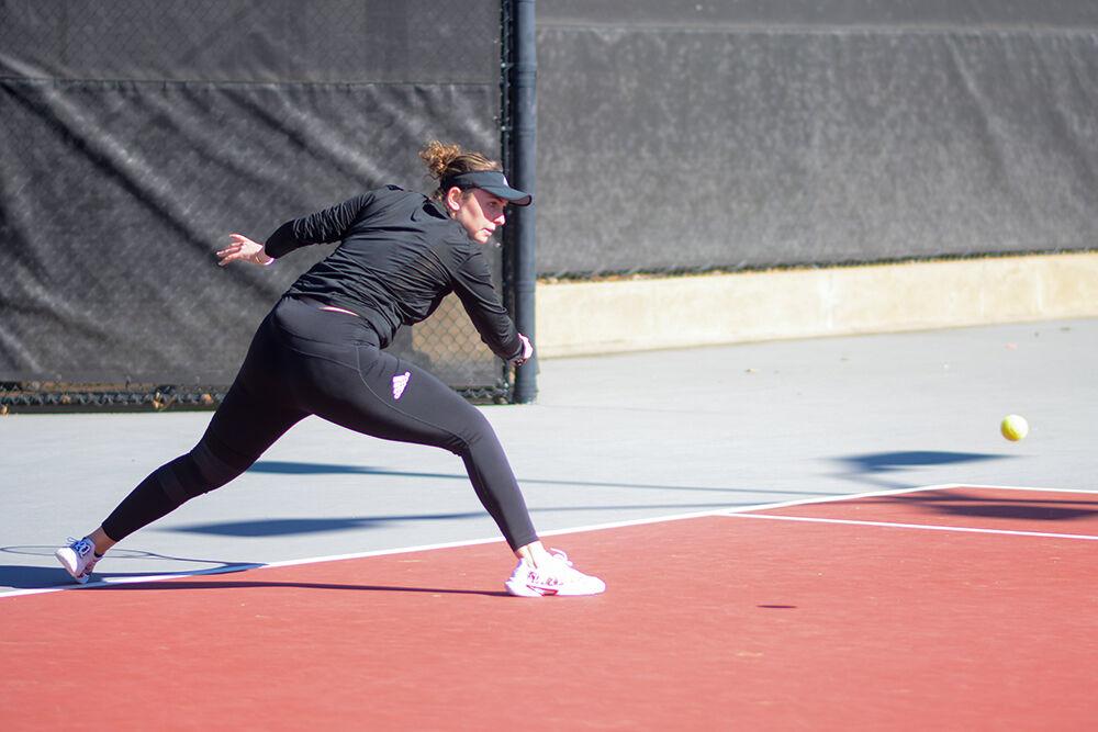 Junior Amelia Rajecki prepares to backhand the ball in her singles match against Illinois at the Dail Outdoor Tennis Stadium on Saturday, Jan. 28, 2023. Rajecki won one of her singles games, but the singles match went unfinished. The Wolfpack won the overall match 4-0.