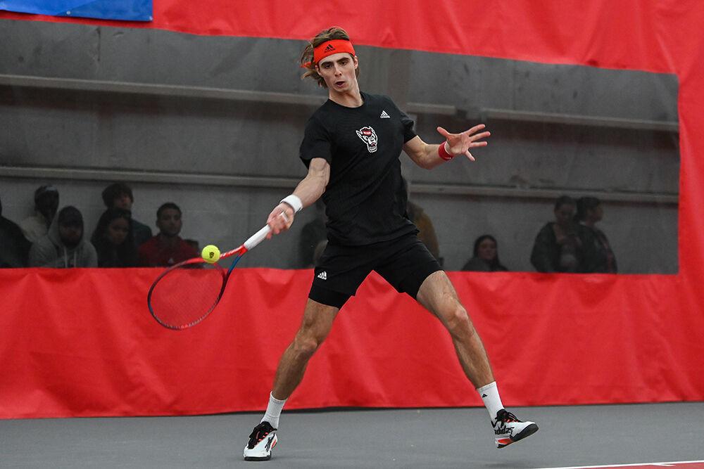 Senior Robin Catry makes a forehanded swing during his singles match against Harvard player Ronan Jachuck at J.W. Isenhour Tennis Center on Friday, Jan. 20, 2023. Catry won the singles match 2-1. NC State lost to Harvard 4-3.