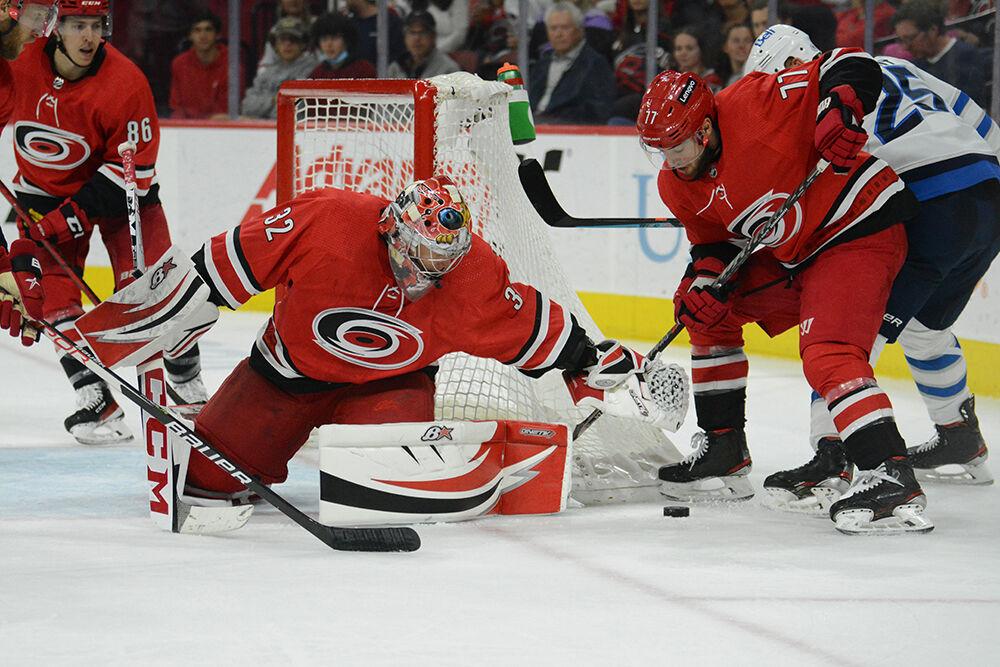 Goaltender Antti Raanta turns to cover the puck in the Canes' home game against the Winnipeg Jets in PNC Arena on Thursday, April 21, 2022. The Canes came from behind to win 4-2 over the Jets.
