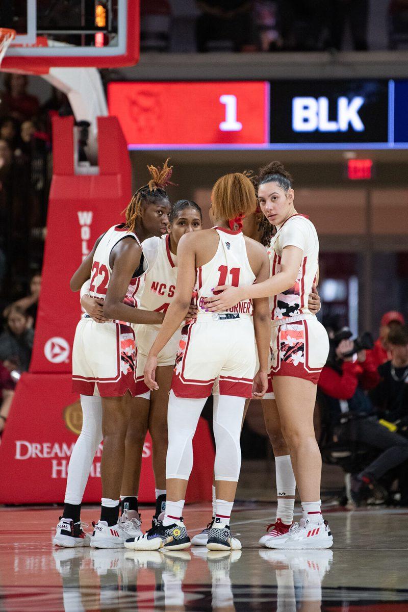The team discusses their plan before a play during the game versus Notre Dame at Reynolds Coliseum on Sunday, Jan. 29, 2023. The Wolfpack beat the Fighting Irish 69-65