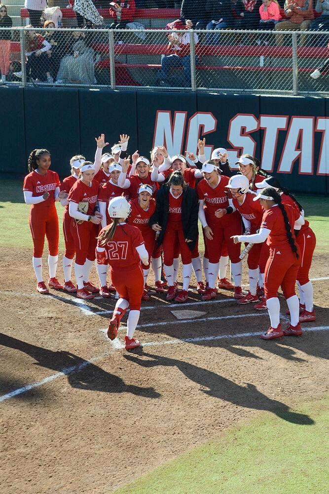 Graduate outfielder Katlyn Pavlick celebrates a home run with the team during the game against Iowa at Dail Softball Stadium on Saturday, Feb 18, 2023. Pavlick hit the only home run for the Wolfpack. NC State won the game 3-1.