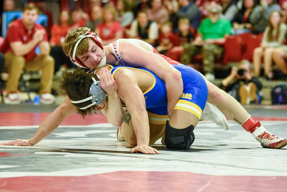 Sophomore Ed Scott wraps his arms around his opponent during the match against Pittsburgh at William Neal Reynolds Coliseum on Friday, Feb. 10, 2023. Scott won his match 15-3. NC State beat Pittsburgh 23-9.