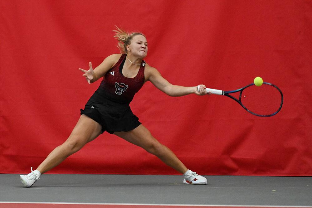 Freshman Diana Shnaider slides forward to forehand the ball during the singles match to return it to Oklahoma player Layne Sleeth at J.W. Isenhour Tennis Center on Saturday, Feb. 4, 2023. Shnaider won both her singles and doubles match. NC State beat Oklahoma 6-1.