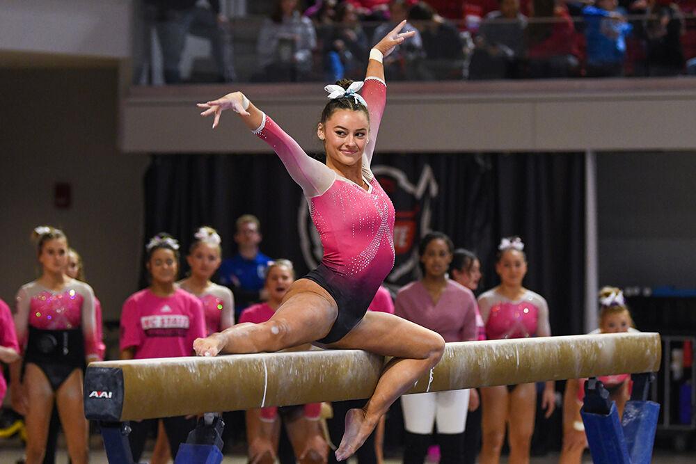 Senior Emily Shepard poses after getting on the balance beam during the meet against UNC-Chapel Hill and Western Michigan at Reynolds Coliseum on Saturday, Feb. 4, 2023. Shepard had the best all around score for the meet, scoring 39.375. NC State beat UNC-Chapel Hill and Western Michigan with an overall score of 196.275.